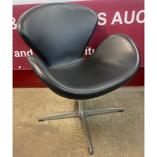 77 - An Arne Jacobsen style black leather and chrome Swan chair