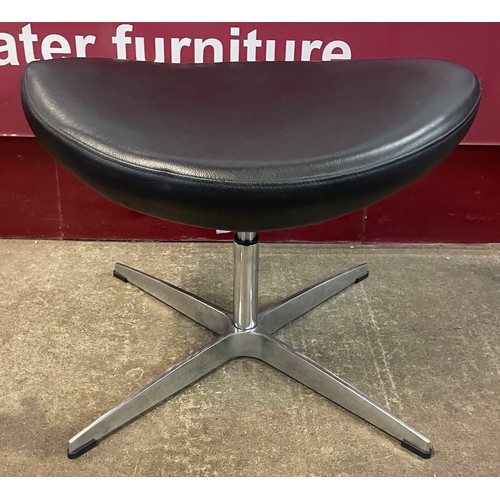 78 - An Arne Jacobsen style black leather and chrome footstool