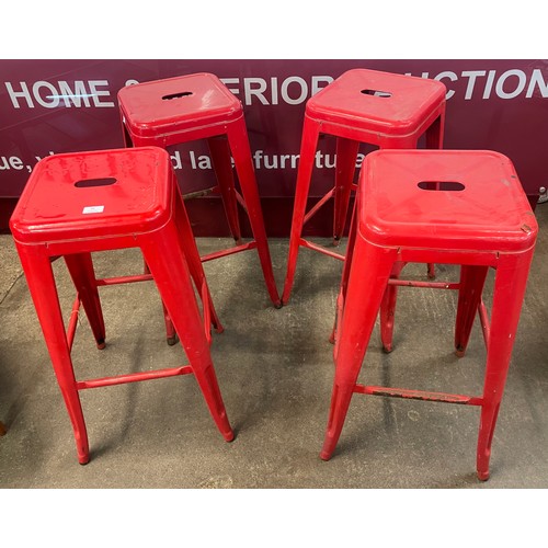 84 - A set of four red metal stacking stools