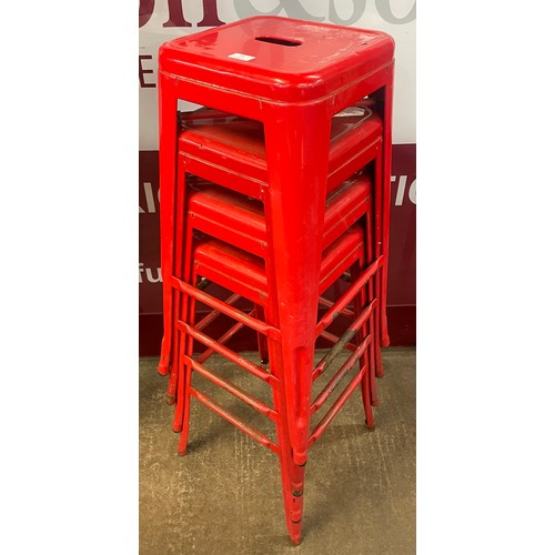 84 - A set of four red metal stacking stools