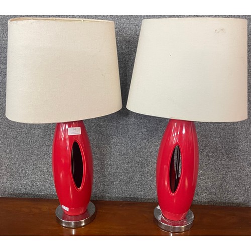 92 - A pair of red ceramic and chrome table lamps