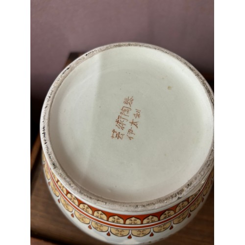 350 - A pair of Oriental ceramic jars and covers