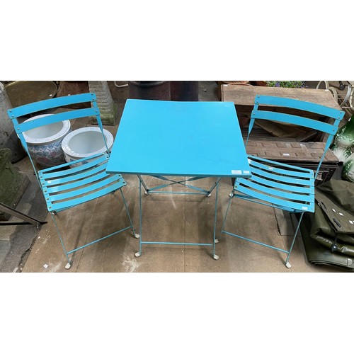 310 - A teal metal garden table and two chairs
