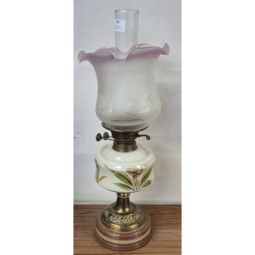 386 - A Victorian brass oil lamp, with painted opaline glass oil reservoir