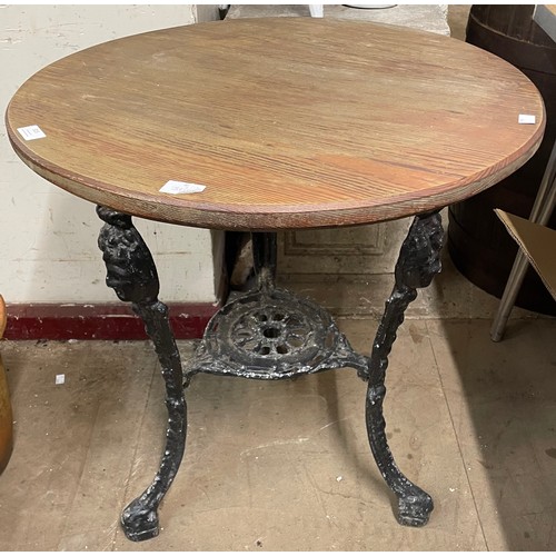 315 - A black painted cast alloy based pub table