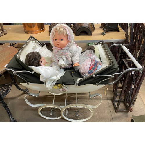 316 - A Silver Cross dolls perambulator, three vintage dolls and a collection of dolls clothing