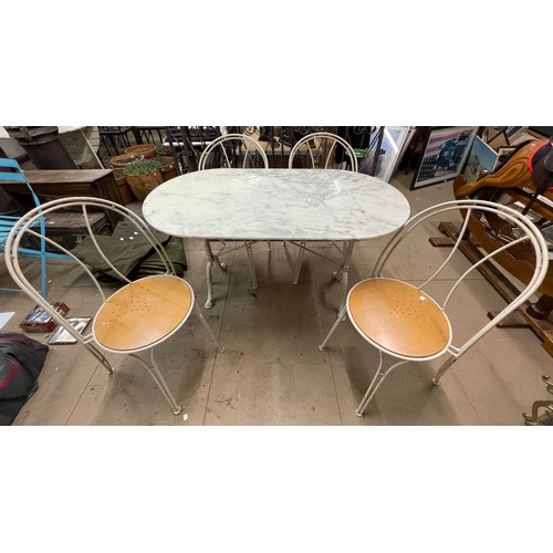 318 - A marble topped garden table and four cast iron chairs