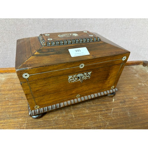 395 - A Regency rosewood and mother of pearl inlaid sarcophagus shaped tea caddy