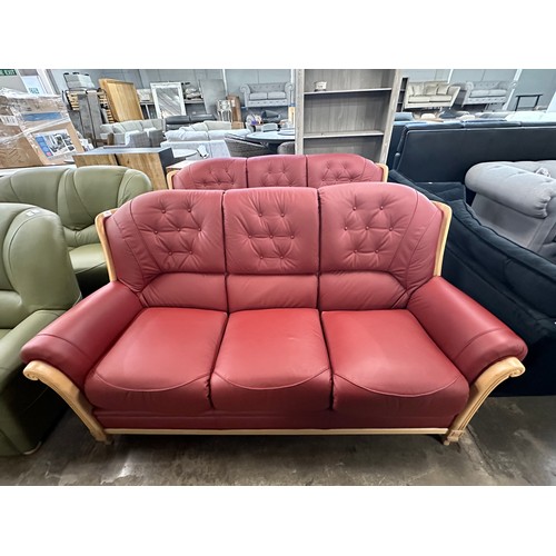 3001 - A pair of red Italian leather buttoned three seater sofas on semi-exposed hardwood frame  *This lot ... 