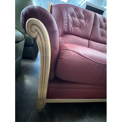 3001 - A pair of red Italian leather buttoned three seater sofas on semi-exposed hardwood frame  *This lot ... 