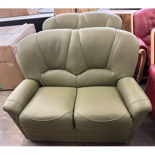 3002 - A pair of green Italian leather two seater sofas  *This lot is subject to VAT