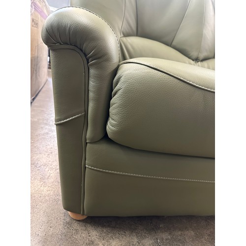 3002 - A pair of green Italian leather two seater sofas  *This lot is subject to VAT