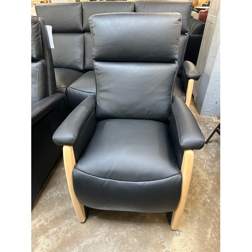 3003 - A black Italian leather three seater sofa, armchair and electric reclining armchair *This lot is sub... 