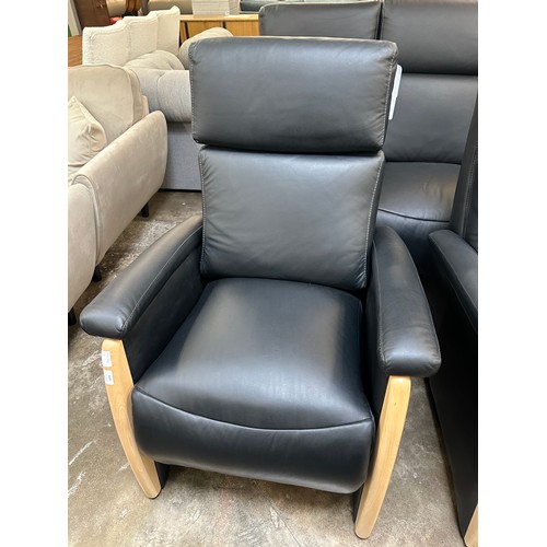 3003 - A black Italian leather three seater sofa, armchair and electric reclining armchair *This lot is sub... 