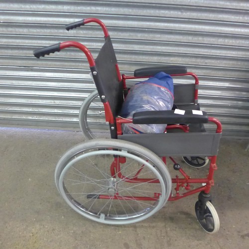 5148A - A large wheeled self propelled wheelchair with footrests and storage bag