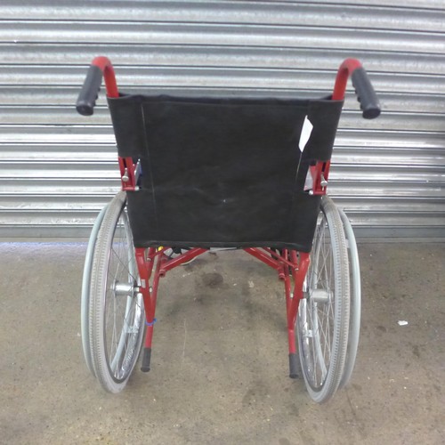 5148A - A large wheeled self propelled wheelchair with footrests and storage bag