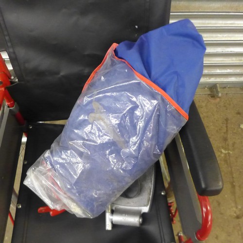 5148A - A large wheeled self propelled wheelchair with footrests and storage bag