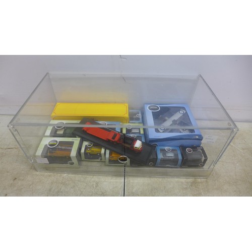 5056A - A collection of Oxford scale models in perspex display case including an AFS Austin ATV, a Nissan Qa... 