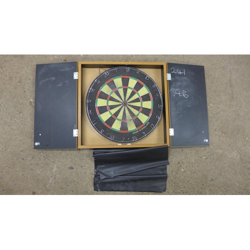 5257 - A dart board in a wooden case