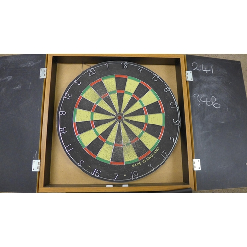 5257 - A dart board in a wooden case