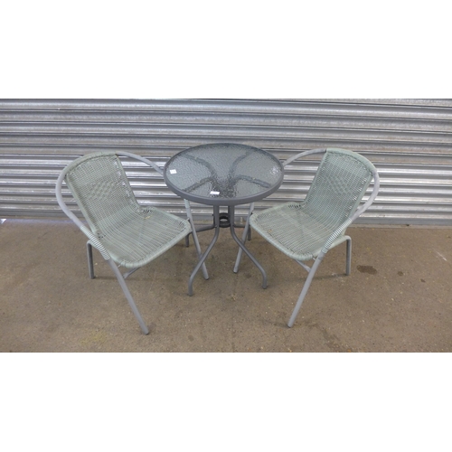 5185 - A circular glass topped bistro garden table and two bistro garden chairs