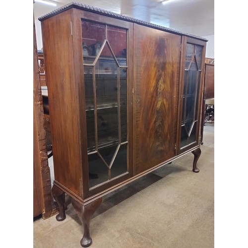 109 - An Edward VII mahogany three door bookcase, by Ray & Miles of Liverpool