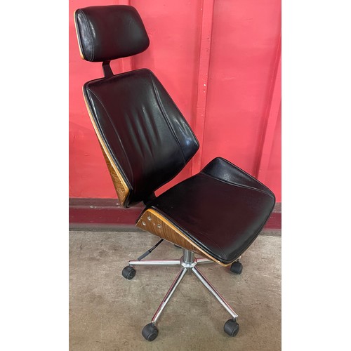 30 - An Eames style simulated rosewood and black leather revolving desk chair