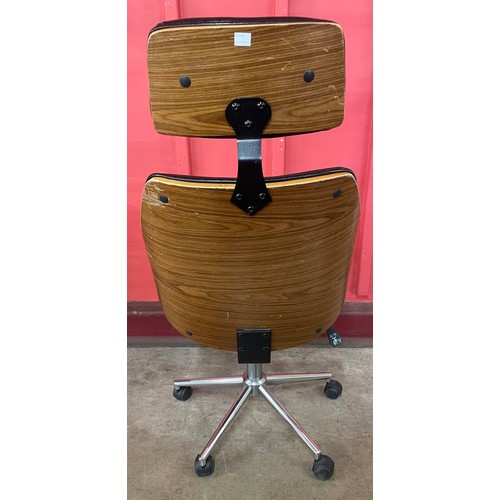 30 - An Eames style simulated rosewood and black leather revolving desk chair