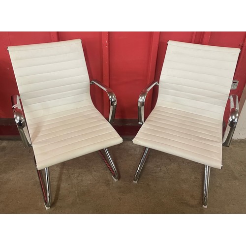 31 - A pair of Eames style chrome & cream leather cantilever desk chairs