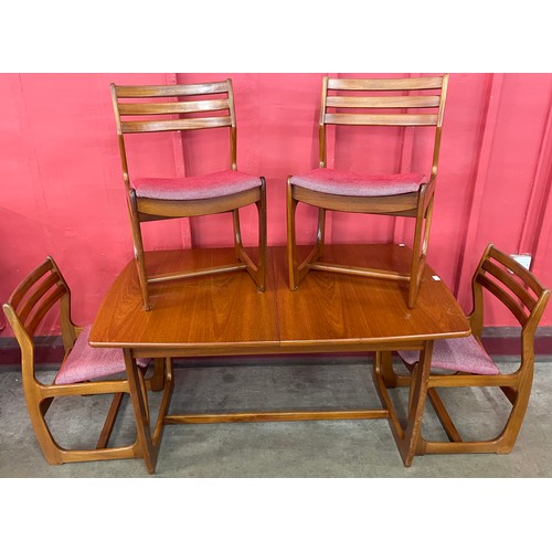 40 - A Portwood teak extending dining table and four chairs