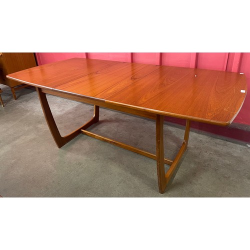 40 - A Portwood teak extending dining table and four chairs