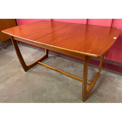 40 - A Portwood teak extending dining table and four chairs