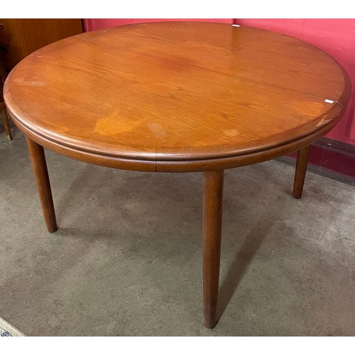 45 - A Danish teak circular extending dining table