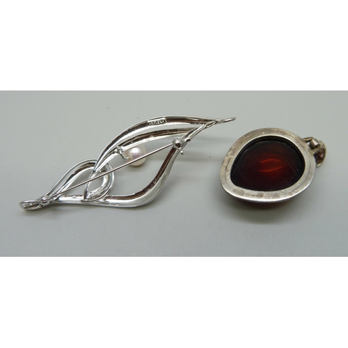 1008 - A silver mounted pendant, a silver and cultured pearl brooch, and a brass seal fob