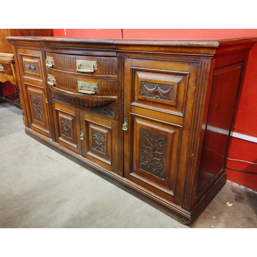 101 - An Edward VII carved walnut bowfront sideboard