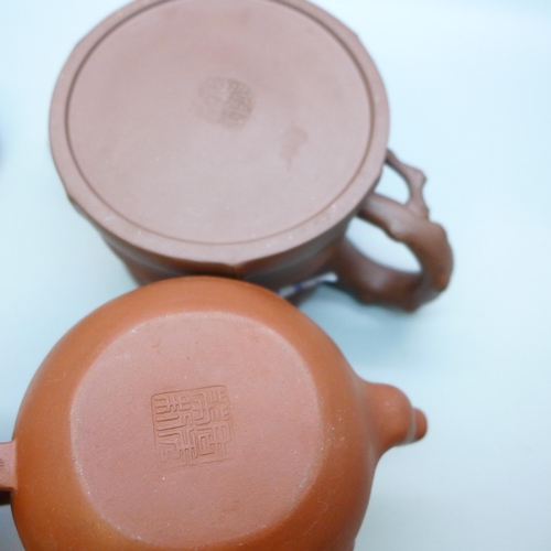 643 - Two Chinese terracotta teapots, each with character mark to base