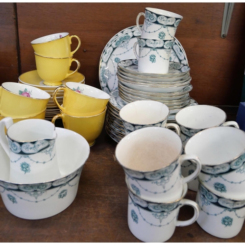 669 - A Jason bone china yellow ground tea set decorated with roses and an Edwardian tea set, ten cups, el... 