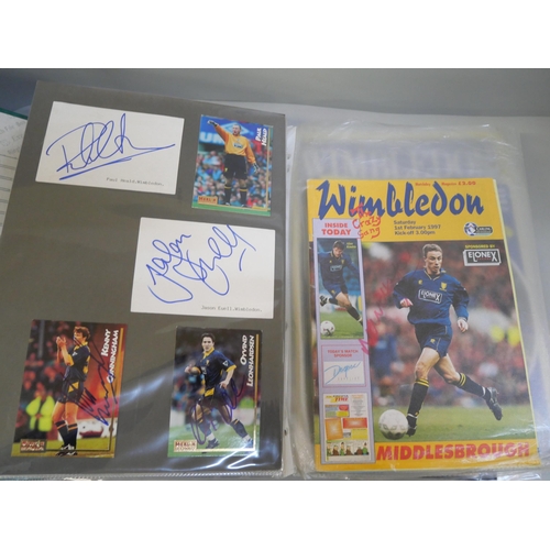 670 - An album containing Wimbledon F.C. autographs and football programmes