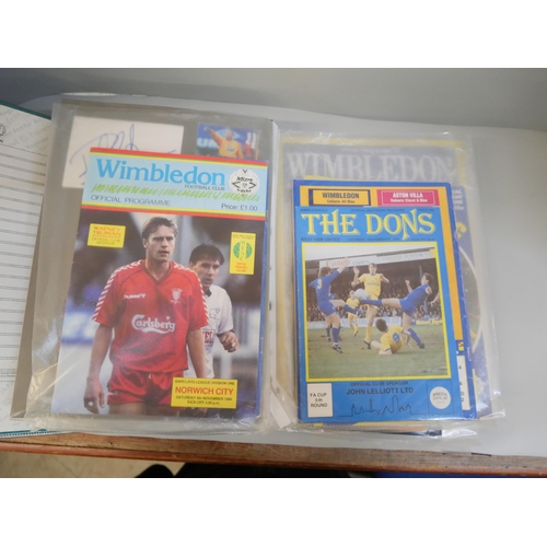 670 - An album containing Wimbledon F.C. autographs and football programmes