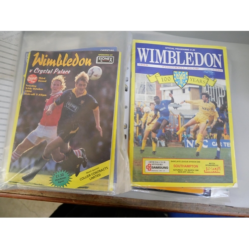 670 - An album containing Wimbledon F.C. autographs and football programmes