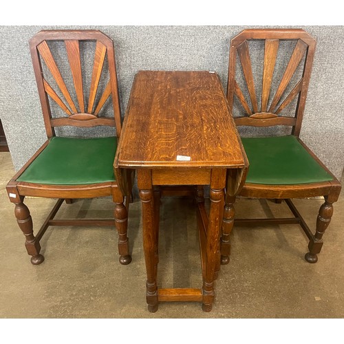 156 - An early 20th Century oak bobbin turned gateleg table and a pair of Art Deco oak dining chairs