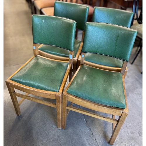 157 - A set of four four oak and green leather upholstered dining chairs