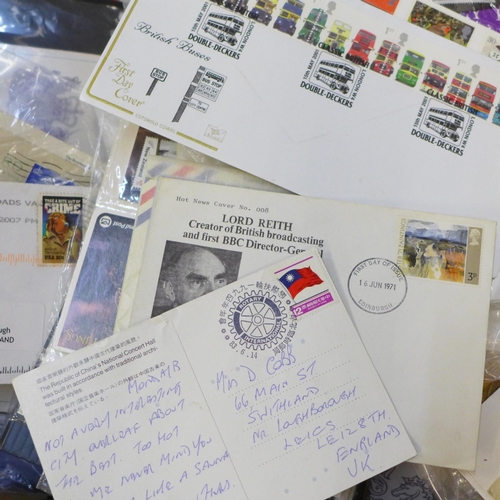 712 - A box of mixed first day covers, stamps, presentation packs, etc., also noted some USA stamps, an al... 