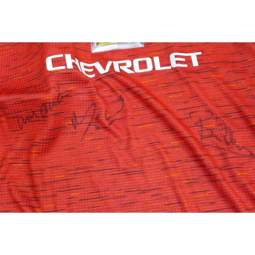 736 - A replica 1980's England football shirt signed by Bryan Robson, also a signed DVD and a signed Manch... 