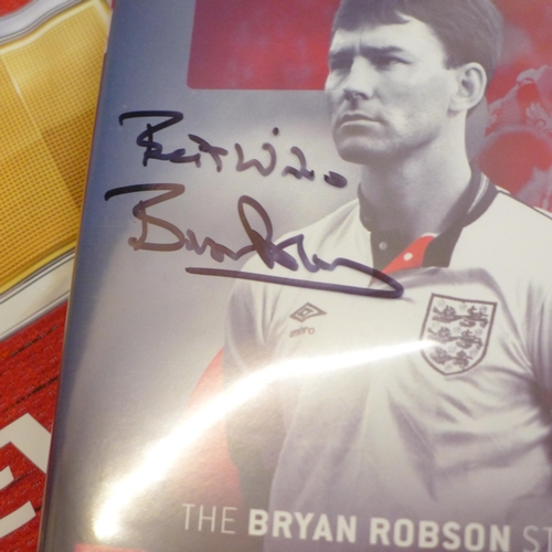 736 - A replica 1980's England football shirt signed by Bryan Robson, also a signed DVD and a signed Manch... 