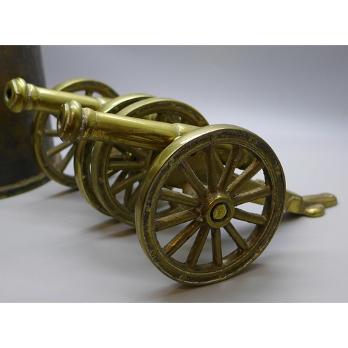 767 - A brass shell case and two brass model cannons