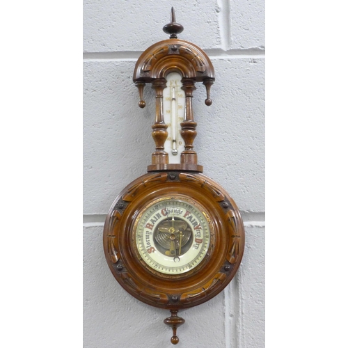 781 - A carved walnut wall barometer