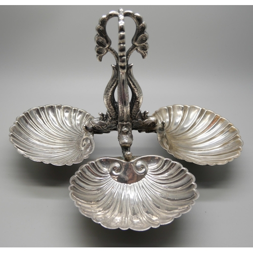 799 - A white metal triple shell silver stand with mythical creature design, continental control marks, a/... 