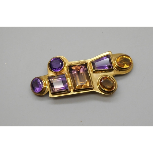 827 - A gilt metal clip set with gemstones including citrine and amethyst, 7.5 x 3cm