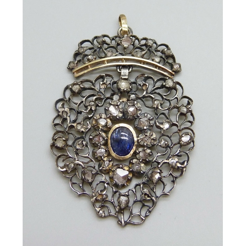 880 - A Georgian white and yellow metal pendant, set with rose cut diamonds and a Ceylon cabochon sapphire... 